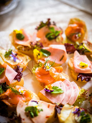 small snacks varnish, ham and edible petals