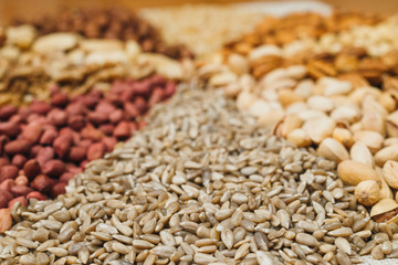 Nuts mix in a canvas bag in table. Ten kinds of nuts: pecan, brazil, cedar, sunflower, hazelnut, almond, peanut, walnut, pistachio, cashew.