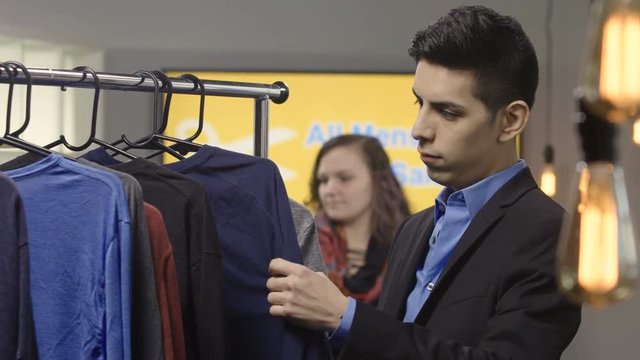 A man shopping for new clothes in a clothing store
