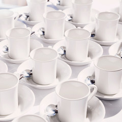 Obraz na płótnie Canvas White cups arranged on the table