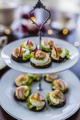 Delicious mini sandwiches on a white plate. 