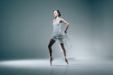 elegant ballerina dancing in white dress