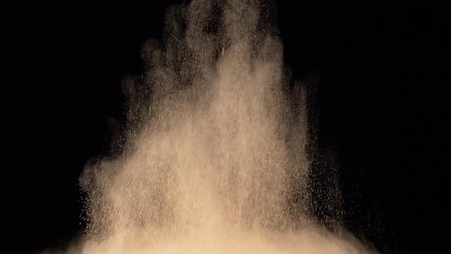 bright yellow powder explosion on black background