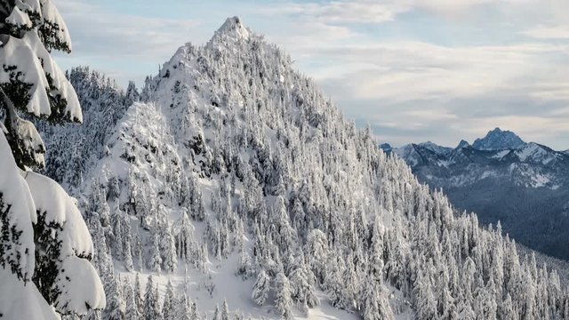 Snow Covered Mountain Timelapse with Thick Forest Trees