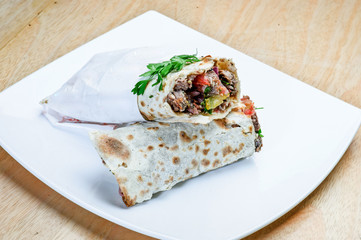 Eastern traditional shawarma plate with sauce.
