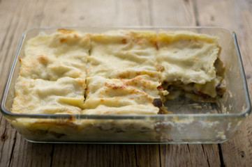 Homemade roasted vegetable lasagna with zucchini, eggplant, red pepper and béchamel on the wooden rustic table
