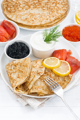 crepes with fish, sour cream and caviar, vertical, top view