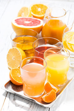 assortment of fresh citrus juices, vertical