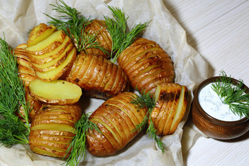 Baked, fried sliced potatoes with fresh dill and sour cream sauce.