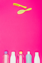 top view of combs and bathroom accessories isolated on pink