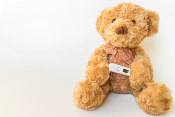 Teddy bear with thermometer and cold