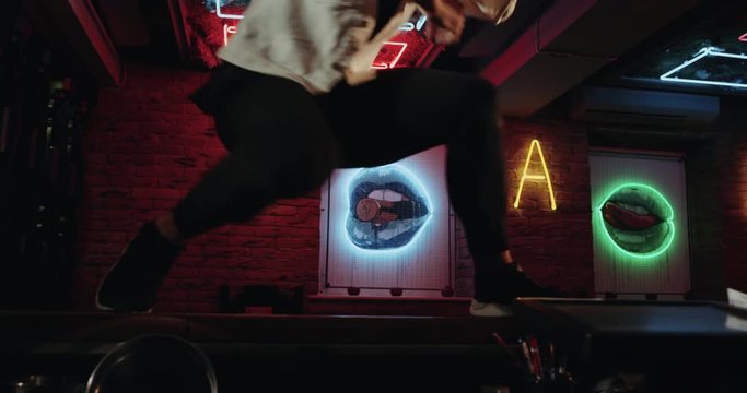 Amazing choreography with a men dancing on the bar table closeup.