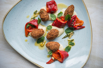 Vegan dish plate, falafel medallion with roasted pepper and hummus