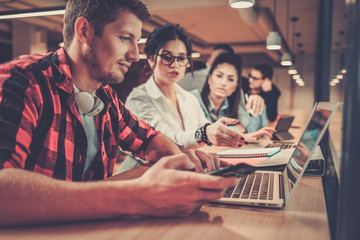 Young colleagues discussing ideas in coworking office
