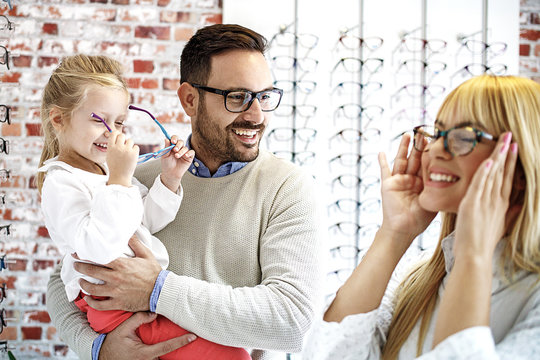 Father and Daughter Choosing Glasses