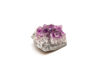 Crystals of amethyst on rock isolated on white background