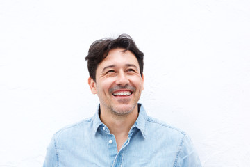 happy older man looking away and smiling isolated on white background