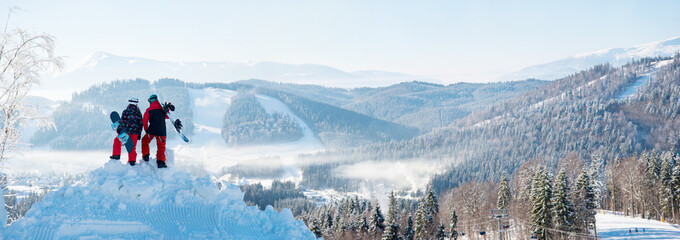 Winter panorama of the Carpathians mountains landscape and forests in a white haze and in the side...