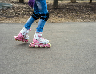 Fototapeta na wymiar Young girl in motion on rollerblading