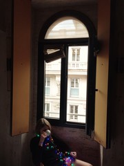 Christmas morning. Girl drinking morning coffee near big window