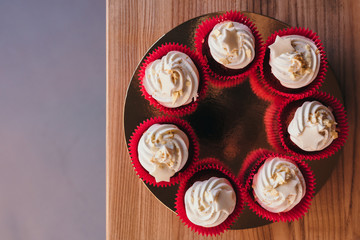 Chocolate cupcakes with  cream cheese icing with space for text. Top view