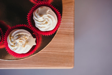 Chocolate cupcakes with  cream cheese icing with space for text. Top view