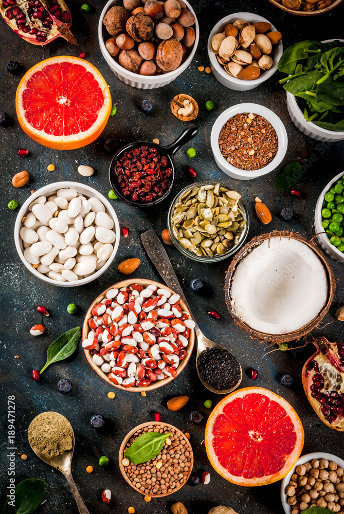 Poster Set of organic healthy diet food, superfoods - beans, legumes, nuts, seeds, greens, fruit and vegetables. Dark blue background copy space top view - Posters