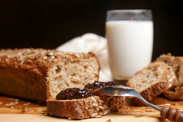Homemade fresh baked bread with jam and glass of milk