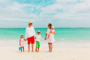 happy family with kids walking at tropical beach