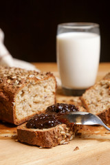 Homemade fresh baked bread with jam and glass of milk