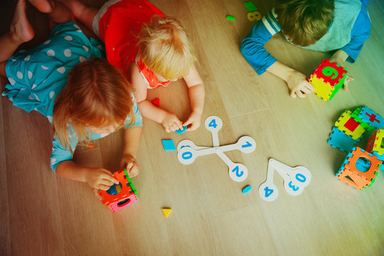 kids learning numbers, calculations, play with puzzle