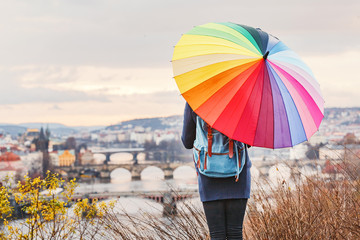 Naklejka premium Girl walking with umbrella on rainy day in historical center of Prague, Europe