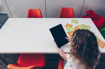 Young girl using a big tablet with touch gesture & pointing finger tap simulation