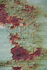 Rusty metal surface with cracked green paint, abstract rusty metal texture, rusty metal background for design with copy space, corrosion