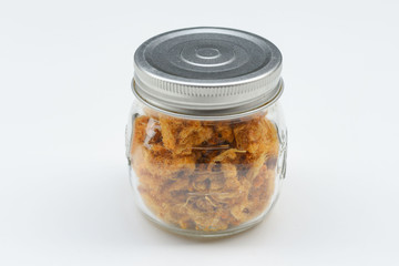 dried shredded pork in a bottle of white ground
