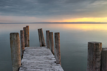 Wooden Pier with Columns on the Lake at Sunset