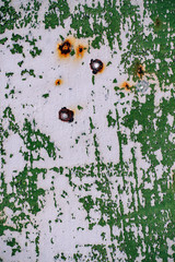  gray painted metal wall with cracked green paint, rust stains, sheet of rusty metal with cracked and flaky green paint , metal background for design with copy space