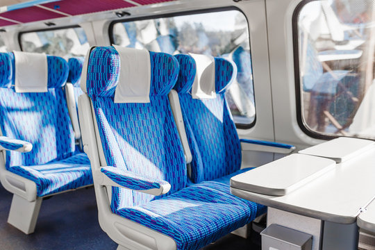 Fototapeta Empty seats in a luxury speed train with table