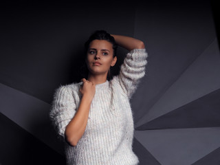 Model cute female brunette at the techno geometry wall background