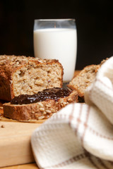 Homemade fresh baked bread with jam and glass of milk