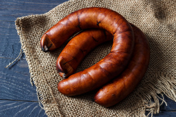 Two sausages on a wooden background