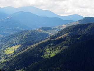 Fototapeta na wymiar Carpatian mountains village at green forest