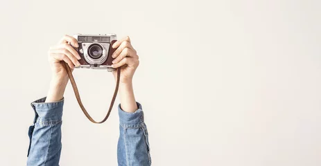 Foto op Plexiglas Arms up holding vintage camera isolated background © sebra