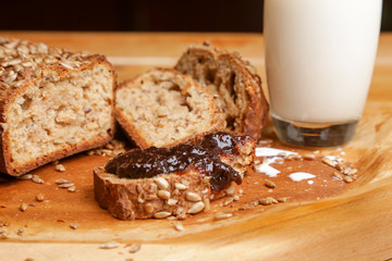 Homemade fresh baked bread with jam and glass of milk