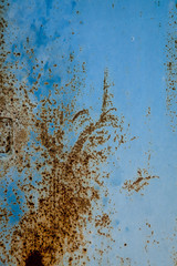 Textured background of blue metal covered with rust