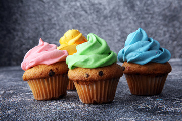 Tasty cupcakes on grey background. Birthday cupcake in rainbow colors
