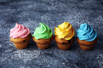 Tasty cupcakes on grey background. Birthday cupcake in rainbow colors
