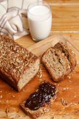 Homemade fresh baked bread with jam and glass of milk