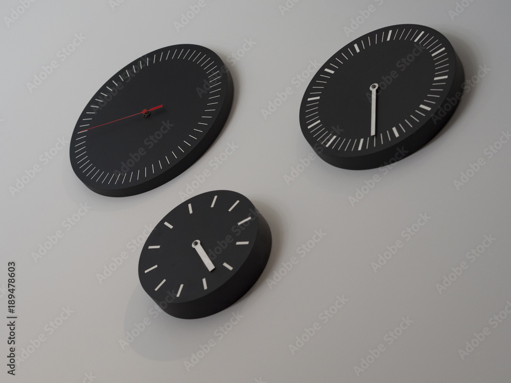 Wall mural Three black clocks with time zone of different countries