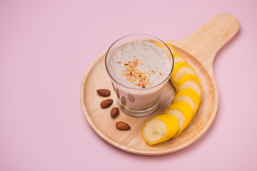 Fresh made Banana smoothie on yellow background